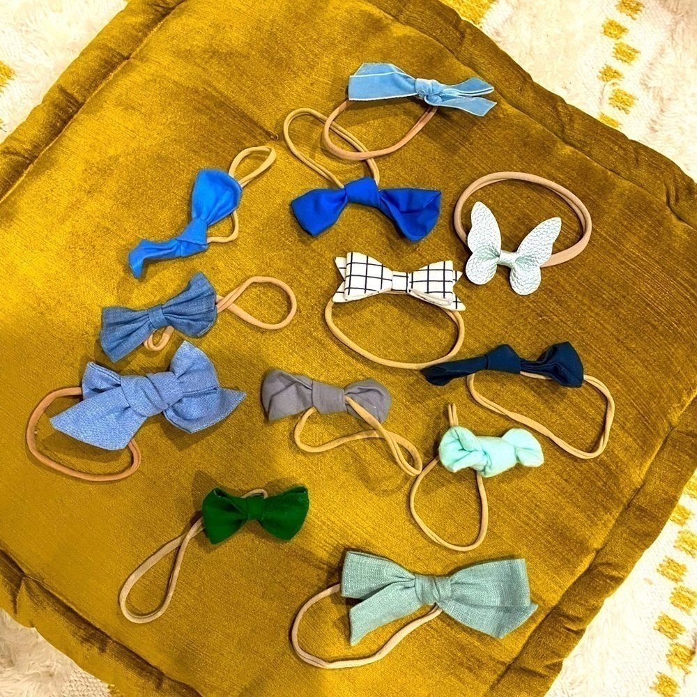 Twelve blue/green baby girl bows